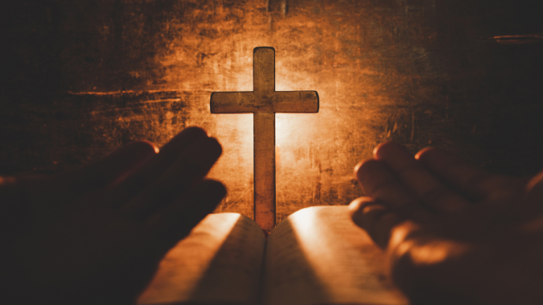 Worship. Reading the bible with your arms open and a cross in front of you